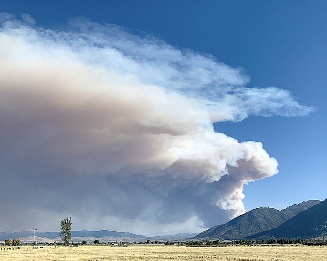 A pyrocumulus cloud rises above a fire burning in Alpine County west of Markleeville.