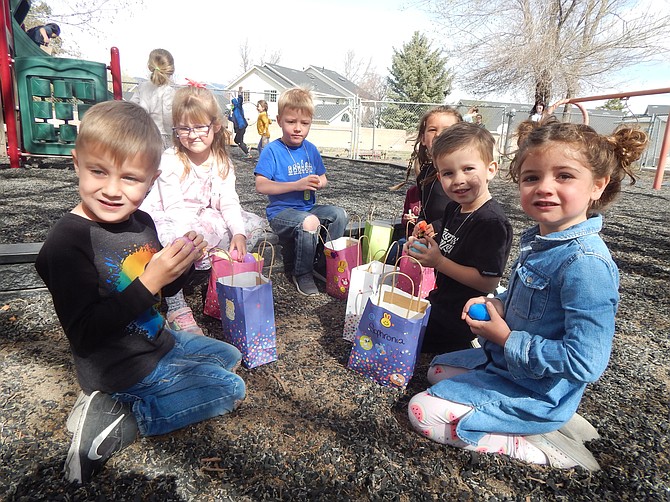 Trinity Lutheran preschoolers confer their findings after Thursday's annual Easter egg hunt at the Gardnerville church school.