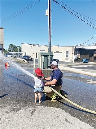 Volunteer firefighters teach fire safety to kids at the library