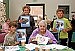 Students present Harmony Manor residents with book they created