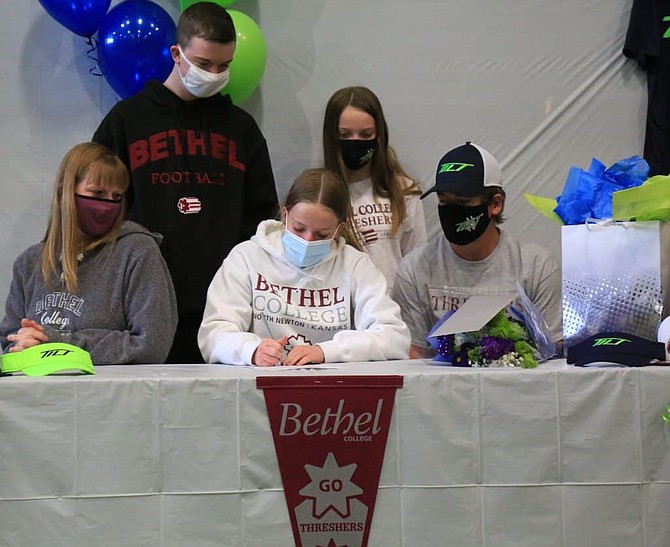 Anna Northcutt signs her Letter of Intent to play softball at Bethel College next year in North Newton, Kansas. Pictured alongside Anna is her mother Jennifer, front left, and father Brian. In back are Anna’s siblings Jackson, left, and Kira.