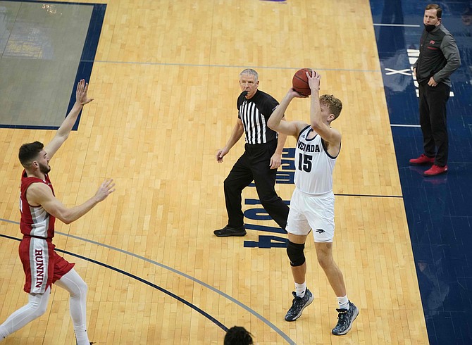 Nevada's Zane Meeks hits a 3-pointer in the corner against the Rebels on Sunday.