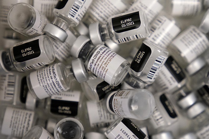 Empty vials of the Pfizer-BioNTech COVID-19 vaccine are seen at a vaccination center at the University of Nevada, Las Vegas on Jan. 22.