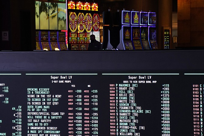 Betting odds for Super Bowl 55 are displayed on monitors at the Circa resort and casino sports book on Wednesday in Las Vegas. (John Locher/AP)