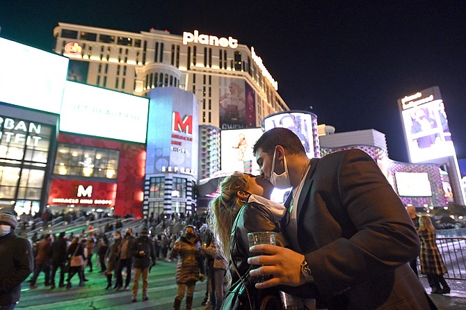 A couple kiss as they celebrate New Year's Eve along the Las Vegas Strip on Dec. 31. (Photo: David Becker/AP)