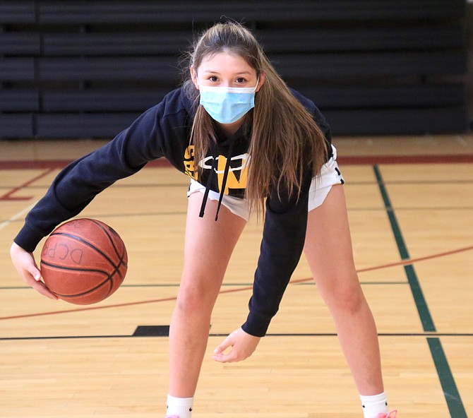 Jaileen Yarrow does a crossover while posing for a photo at the Douglas County Recreation Center. Yarrow has traveled to over 25 states to play competitive basketball and is hoping to make an immediate impact with Bishop Manogue.