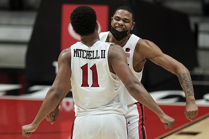 San Diego State forward Keshad Johnson, right, and forward Matt Mitchell (11) celebrate a point during the second half of an NCAA college basketball game against Boise State Saturday, Feb 27, 2021, in San Diego. (AP Photo/Gregory Bull)
