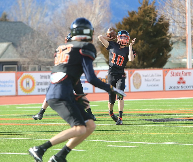 Douglas High quarterback Aden Flory throws a pass during practice to wide receiver Dominic Costarella during practice last week. Flory will be the starting quarterback for the Tigers this spring.