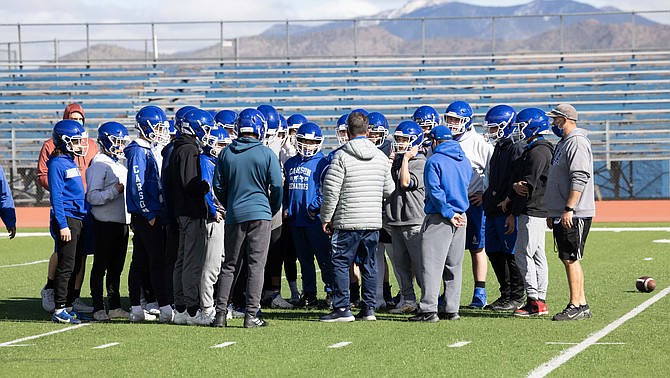 The Carson High football team listens to head coach Blair Roman during practice last week. The Senators will have plenty of youth on the roster this season, but Roman and the rest of the coaching staff expects to see some bright spots turn out after the shortened season.