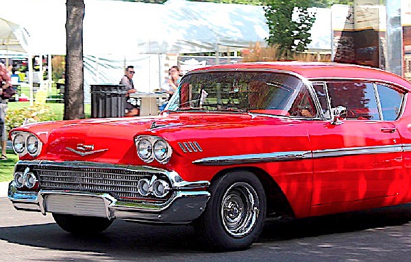 A classic car drives through Minden during the Hot August Nights poker run in 2019.