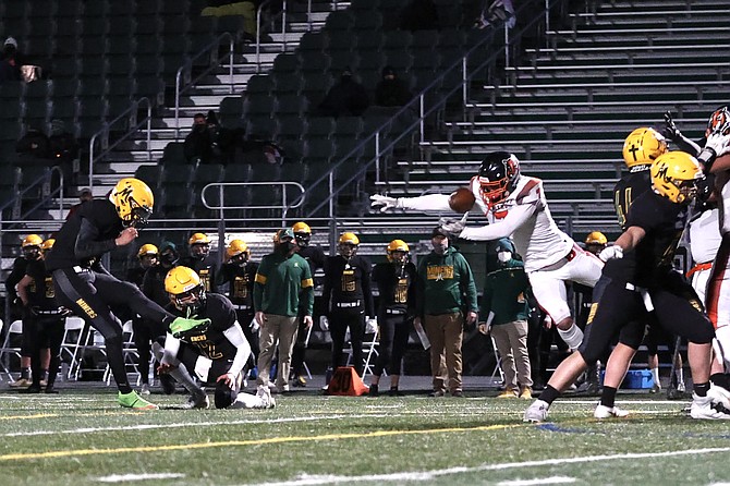 Douglas High senior captain Brady Dufloth comes around the left edge and blocks a Bishop Manogue field goal attempt Friday night. It's the second kick the Tigers' special teams has blocked in as many games so far this season.