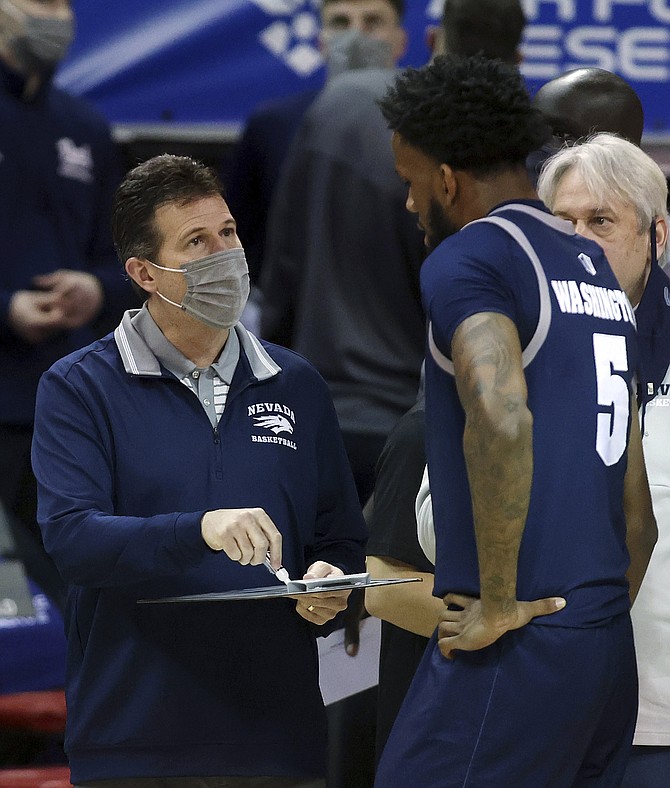 Nevada coach Steve Alford talks with forward Warren Washington (5) during the second half of the team's NCAA college basketball game against San Diego State in the semifinals of the Mountain West Conference men's tournament Friday, March 12, 2021, in Las Vegas. (AP Photo/Isaac Brekken)