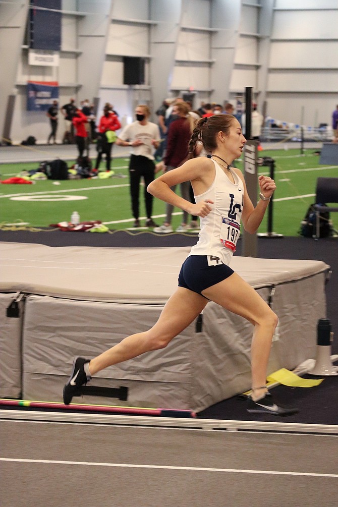 Carson High graduate and Lewis-Clark State College sophomore Ashley Britt runs around a turn at Mount Marty University during the NAIA Indoor Championships in early March.