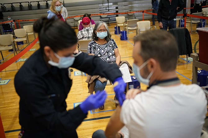 People receive the COVID-19 vaccine at a vaccination site in Las Vegas on Feb. 17. (Photo: John Locher/AP)