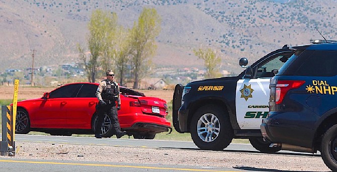 A deputy walks away from the red Audi that was the vehicle involved in a May 1, 2020, pursuit into Douglas County.