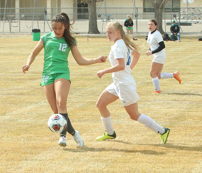 Sydney Gusewelle (12) of Fallon controls the ball against Lowry's MacKenzie Swenson in the Lady Wave’s win on Friday.