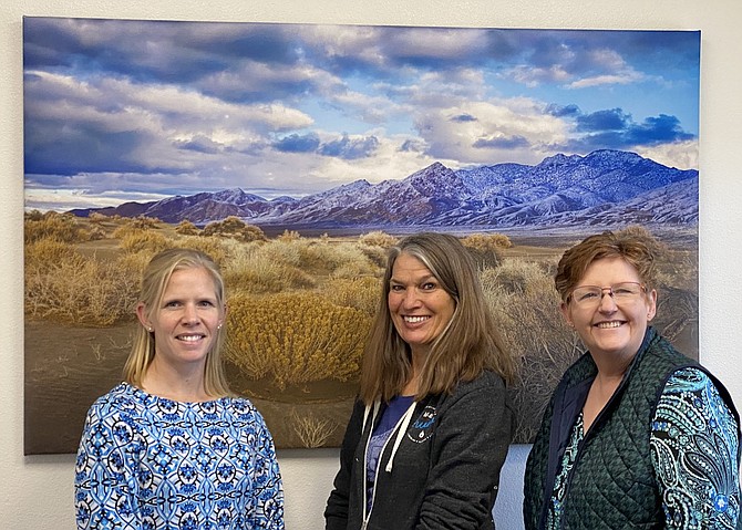 Casey Pomeroy, left, owner of Western Nevada Title, recently acquired new photos from photographer, Marie Nygren, center, which were printed by Suzie Slaybaugh, owner of Suzie's Picture Framing.