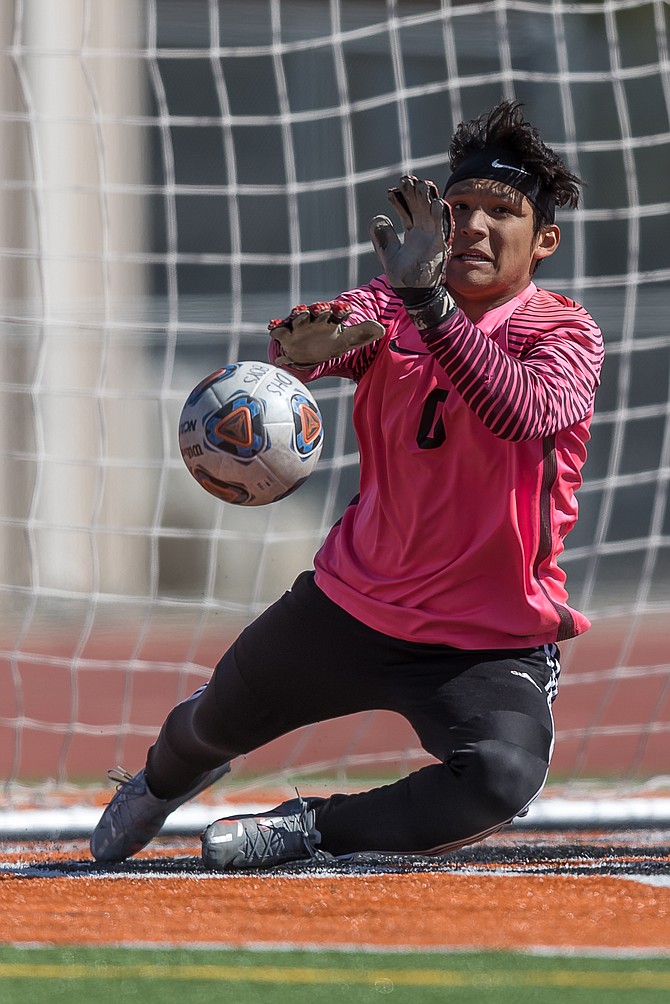 Emilio Munoz makes a diving save in Douglas High’s 0-0 draw against South Tahoe Monday.