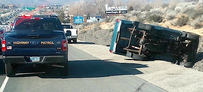A green pickup rolled over after trying to avoid stopped vehicles on Highway 395 during the Thursday evening commute.