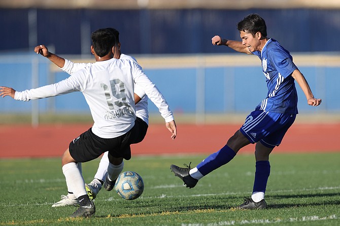 Carson High's Jose De La O (10) rips a shot Tuesday night in the Senators' Class 5A regional quarterfinal contest against Hug. The Hawks escaped with a 1-0 win in overtime.