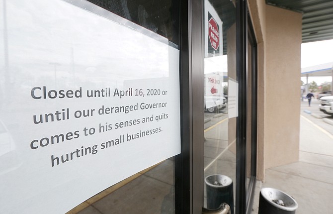 A sign taped the doors at the temporarily closed Lovelock Chevron Casino in early April 2020 protests Governor Steve Sisolak’s closure orders.