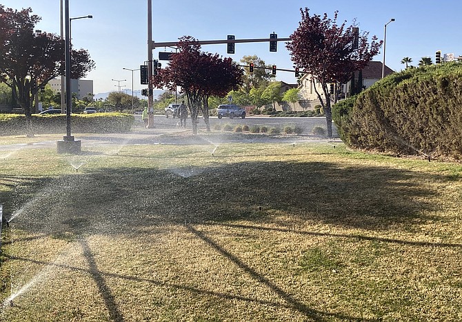 Sprinklers water grass near a street corner April 9 in the Summerlin neighborhood of northwest Las Vegas. (Photo: Ken Ritter/AP)