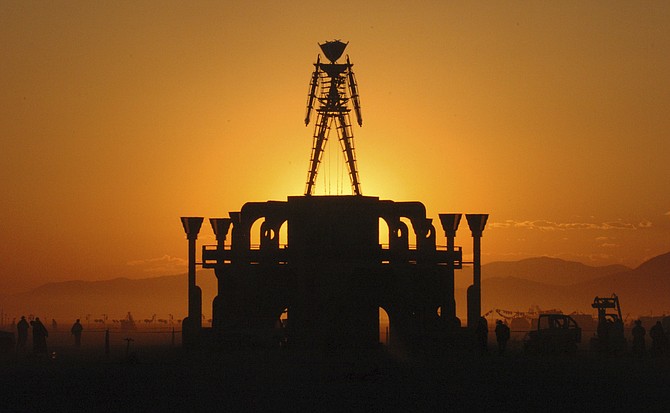 The Man, a symbol of the Burning Man art festival, is silhouetted against a morning sunrise in the Black Rock Desert on Sept. 2, 2006. (Photo: Ron Lewis/AP, file)