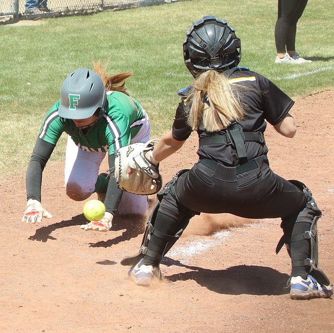 Lowry catcher Alexus Gomez is late with the tag on Shaylee Fagg, who scored a run for Fallon.