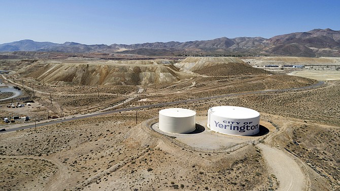 Water tanks for the town of Yerington, with the abandoned Anaconda mine pit, source of an underground plume of poisonous water in the background, are seen April 27, 2018. (Photo: Scott Sady/AP, file)