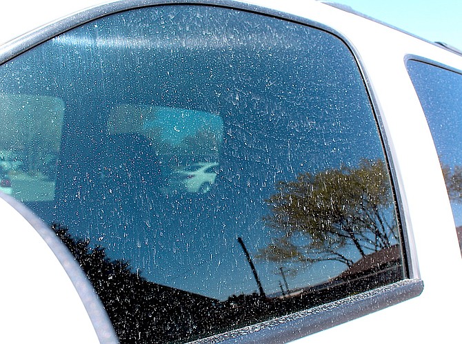 Fine lines of dust cover a truck window in Gardnerville on Thursday morning.