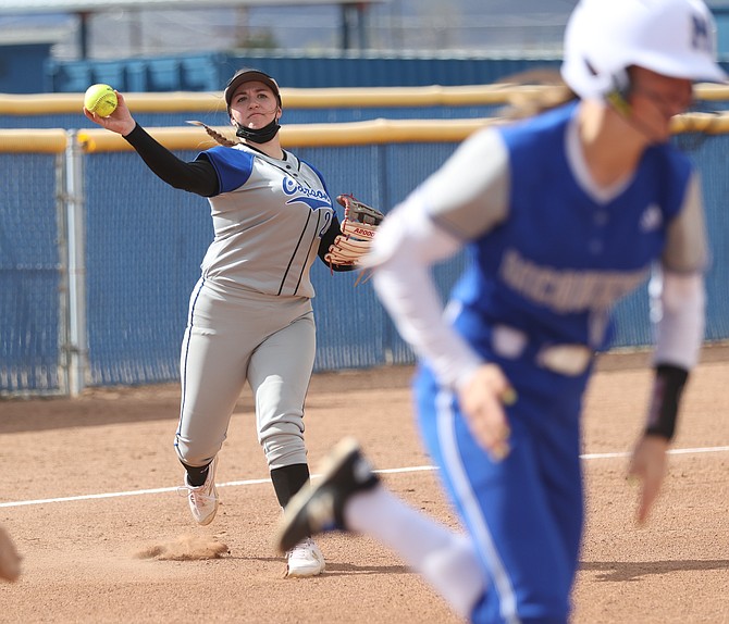 Amaya Mendeguia throws to first base against McQueen last week for a put out. Mendeguia and the Senators swept Bishop Manogue this weekend in a doubleheader.