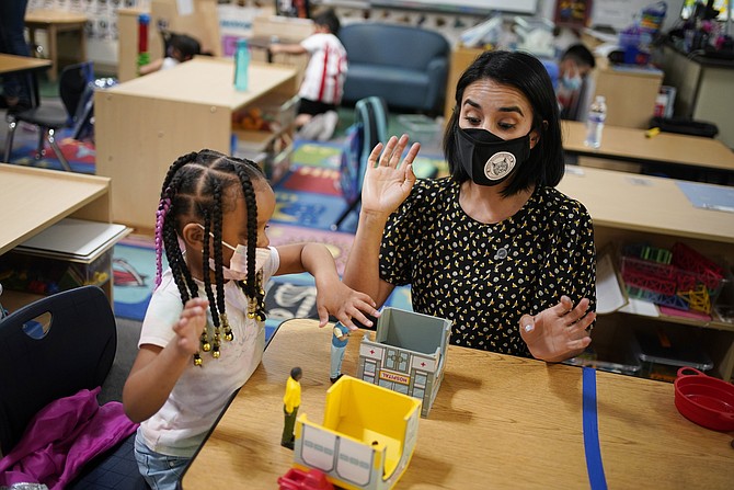 Teacher Juliana Urtubey, right, works with A'Real Wilkerson-Lay in a class at Kermit R. Booker Sr. Elementary School on Wednesday in Las Vegas. (John Locher/AP)