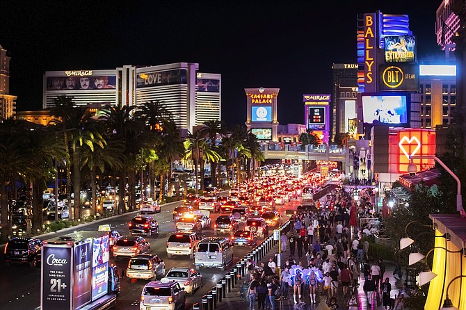 Vehicles and crowds move along the Strip in Las Vegas on March 19. (Photo: Benjamin Hager/Las Vegas Review-Journal via AP)