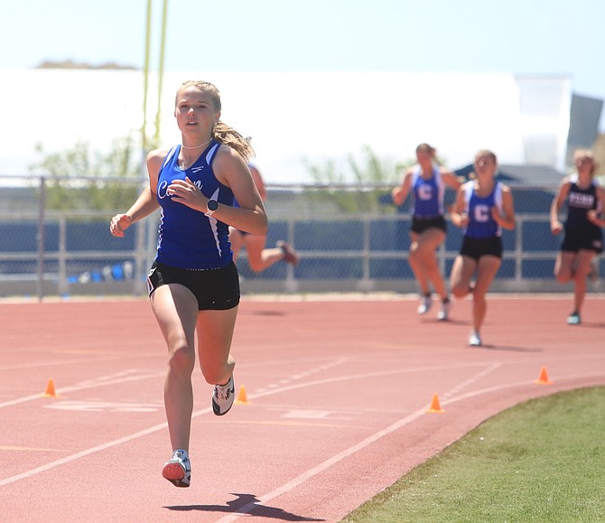 Carson High junior McKenna Budd runs without anyone behind her in the 800-meter run Saturday afternoon at Carson High.