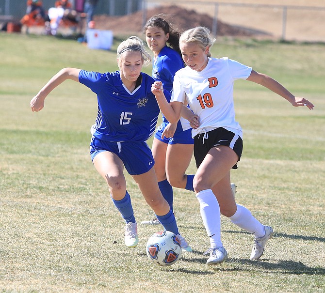 Bailey Rozier works around a McQueen defender during the Class 5A regional semifinal game this spring. Rozier was named a first team all-region midfielder for her performance this season.