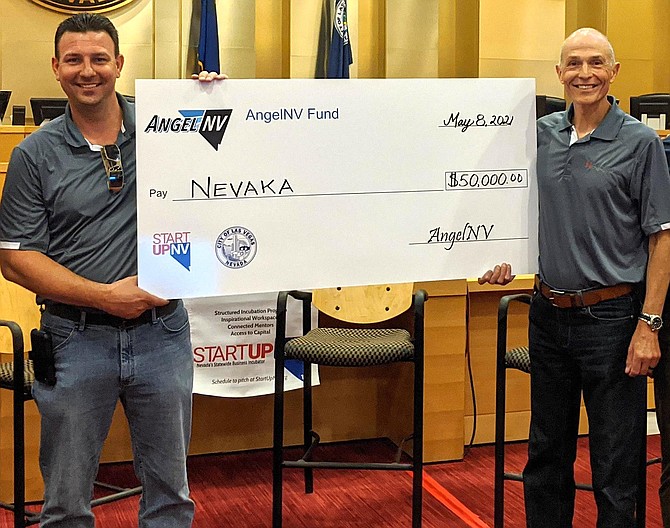 Nevaka co-founders Chris Paris, left, and Mark Aston, right, hold their runner-up check after the May 8 AngelNV event.