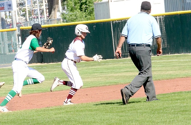 Fallon shortstop Brady Alves chases Dayton’s Caleb Sumsion back toward first base. Sumsion was trying to steal second, but Alves tagged him out. (Photo: Steve Ranson/LVN)