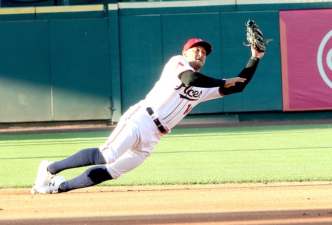 Reno second baseman Christian Lopes leaves his feet to make a leaping catch against Las Vegas. (Photo: Steve Ranson/LVN)