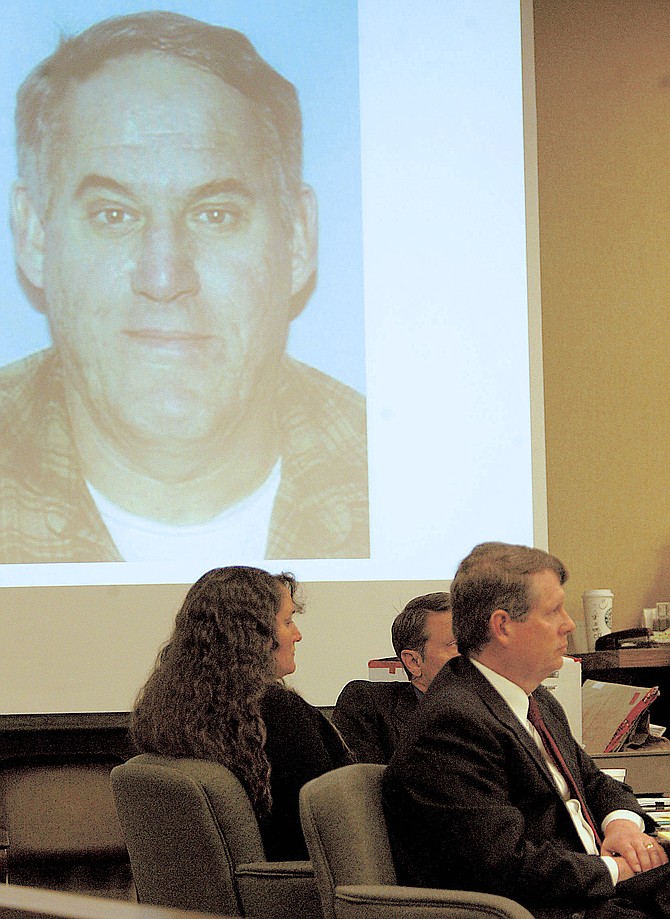 Karen Bodden sits with her attorneys as a photo of her murdered husband Robin appears on the screen above them in this 2008 file photo by R-C Photographer Shannon Litz.