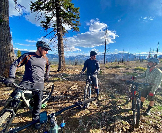 Mountain bikers take a break during a ride on the Tahoe Mountain Trail.