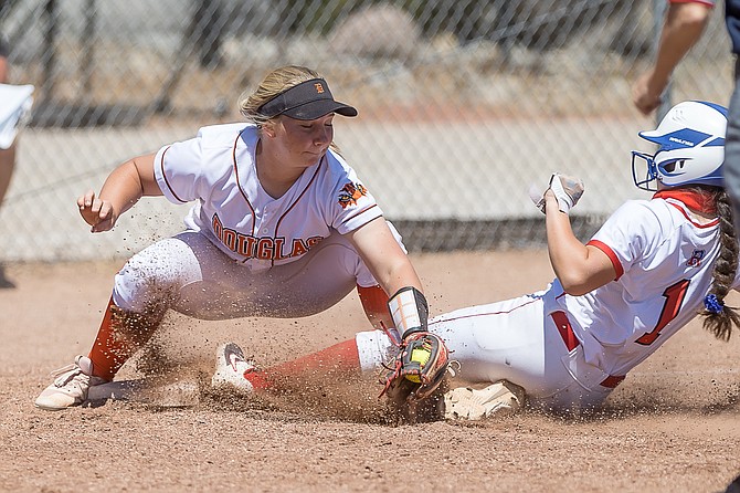 Douglas High's Emma Glover makes a tag out at third base during a contest against Reno earlier this season. Glover and the Tigers bested Reno to open regional play Tuesday.