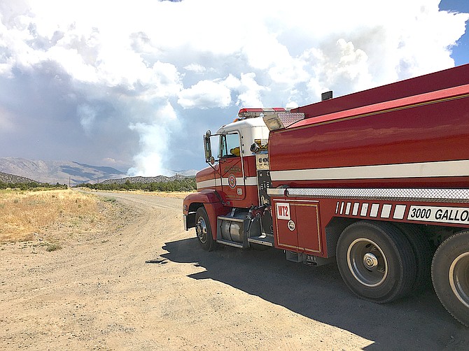 Gardnerville Tender 2 rolls with lights and sirens toward a fire burning in the Pine Nuts in June 2020.