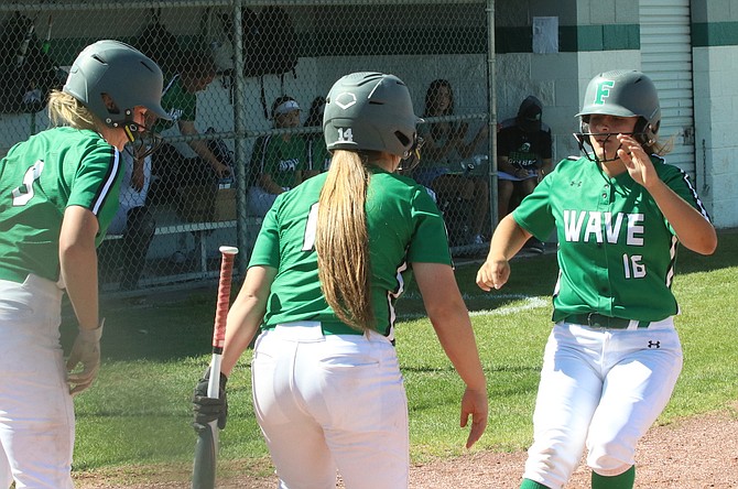 Rachel Mori (16) is greeted at home after hitting a home run, her first of two against Lowry, in Tuesday’s softball game. (Photo: Steve Ranson/LVN)