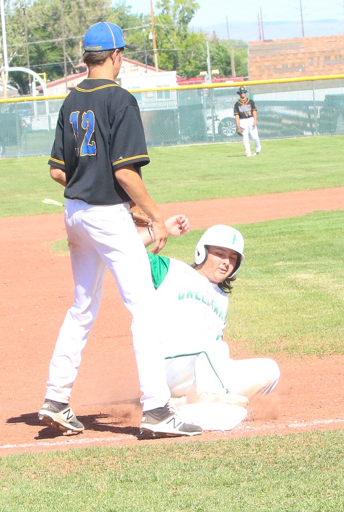 Kodus Wehe of the Greenwave slides into third base with Lowry’s Kaden Boyles covering the bag. (Photo: Steve Ranson/LVN)
