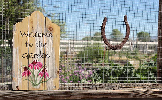 The sign on the gate to Heritage Park Gardens welcomes visitors.