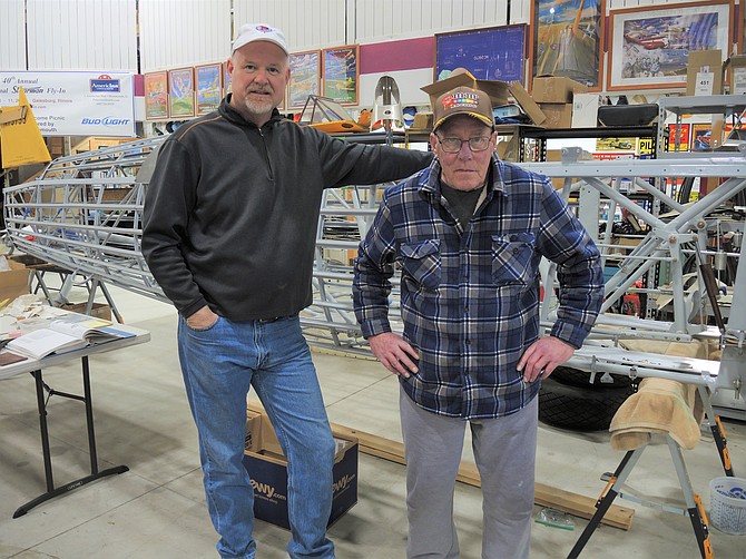 Pictured from left to right are Dayton residents Darrell Fisher, CEO of Dream Flights, and Doug Ellis, crew chief, in Fisher’s aircraft hangar.