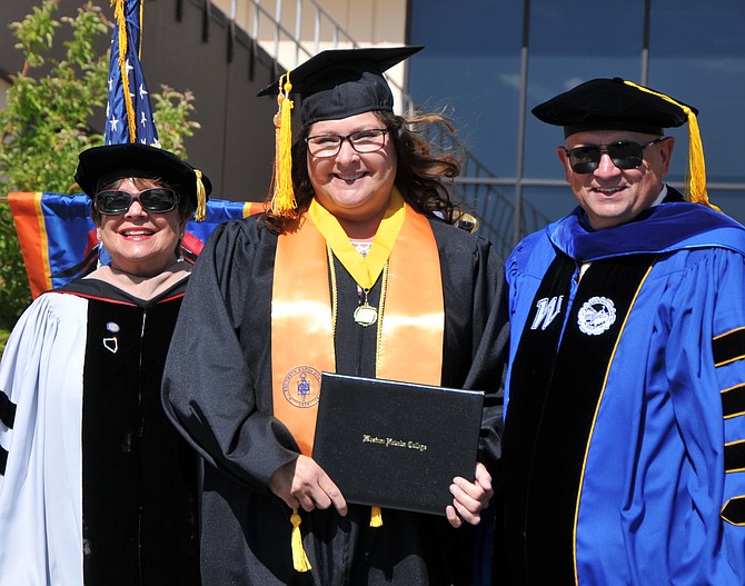 Western Nevada College graduate Sue Donaldson stands with Regent Carol Del Carlo and Dr. Vincent Solis Tuesday as she receives her Bachelor of Applied Science degree in construction management.