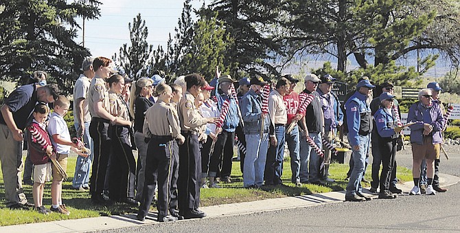Volunteers gather on the Friday before Memorial Day 2020 to place flags on veterans' graves.