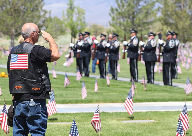 A veteran offers a salute to the ceremonial team on Memorial Day at the Northern Nevada Veterans Memorial Cemetery in Fernley. (Photo: Steve Ranson/LVN)