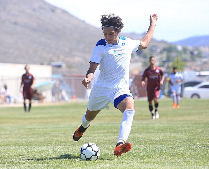 Angel Gonzalez winds up prior to scoring his second goal Saturday for Battle Born FC in the club’s first-ever home contest, conducted on the Carson High practice soccer field.
